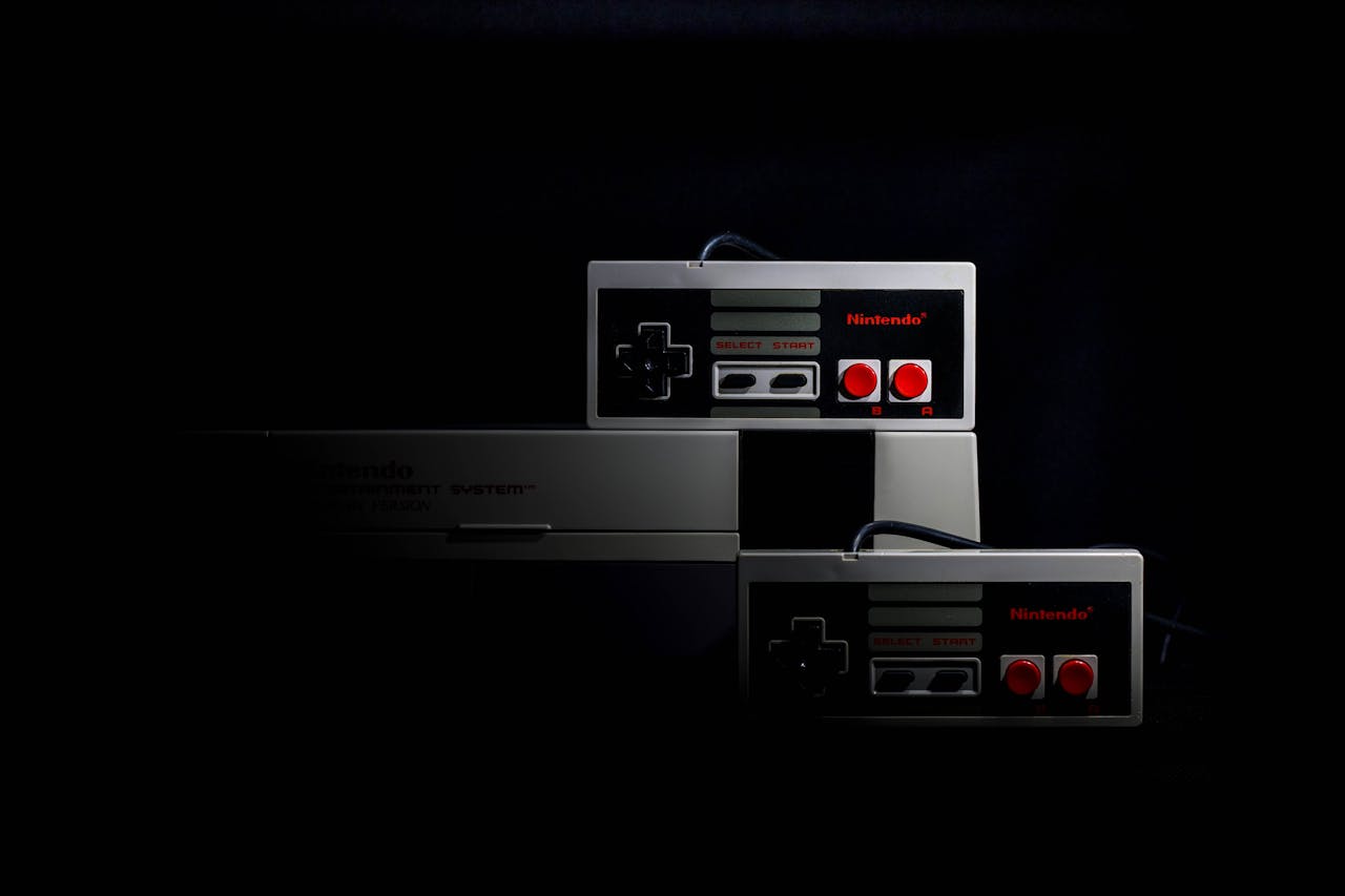 Retro gaming controllers from the Nintendo Entertainment System in low-key lighting, evoking nostalgia.